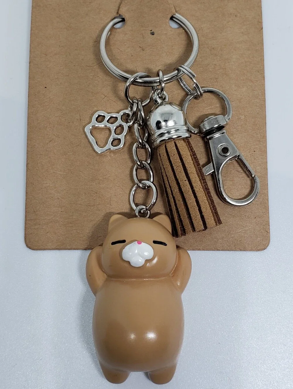 Handmade painted resin light brown tan cat paw keychain
